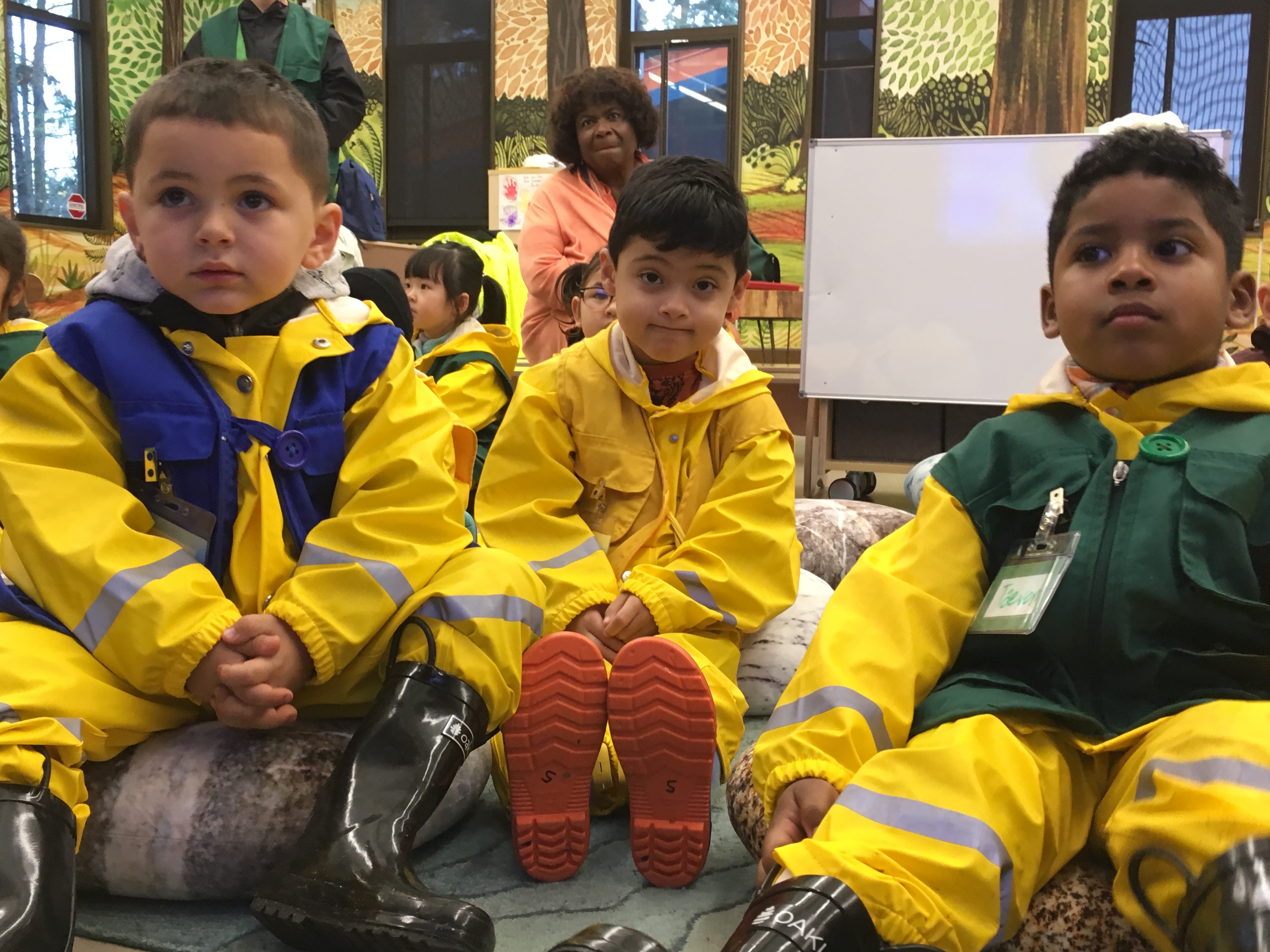 NATURAL CURIOSITY—Superintendent Carla Santorno looks on as visiting preschool students prepare for a nature hike in the rain at the Science and Math Institute, also known as SAMI, which may be the only high school in the nation that’s located inside a zoo.