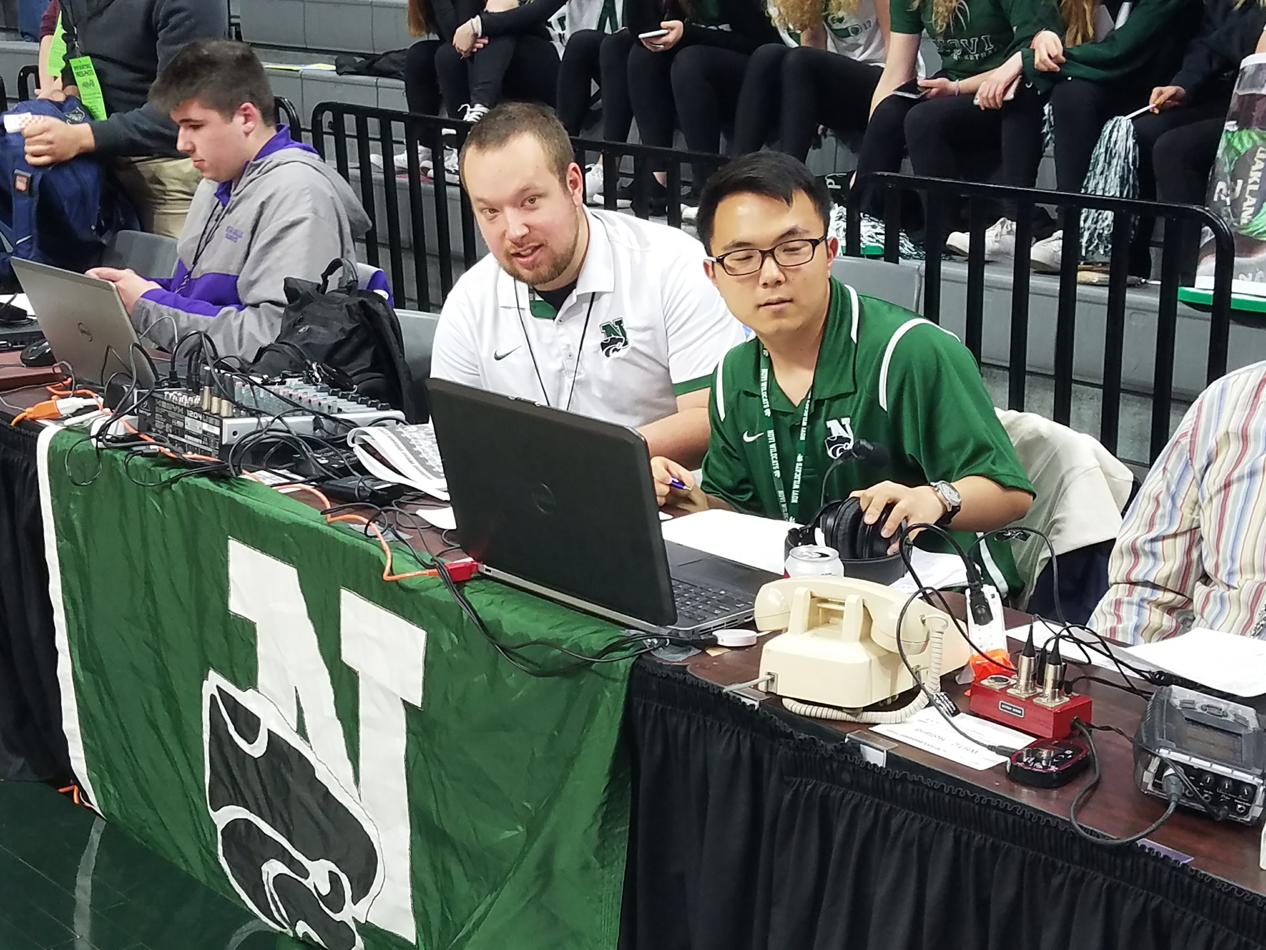 GIVING AI A HUMAN TOUCH—A high school sports broadcast team at Novi High School in Michigan adds play-by-play to the live streaming of a basketball game. 