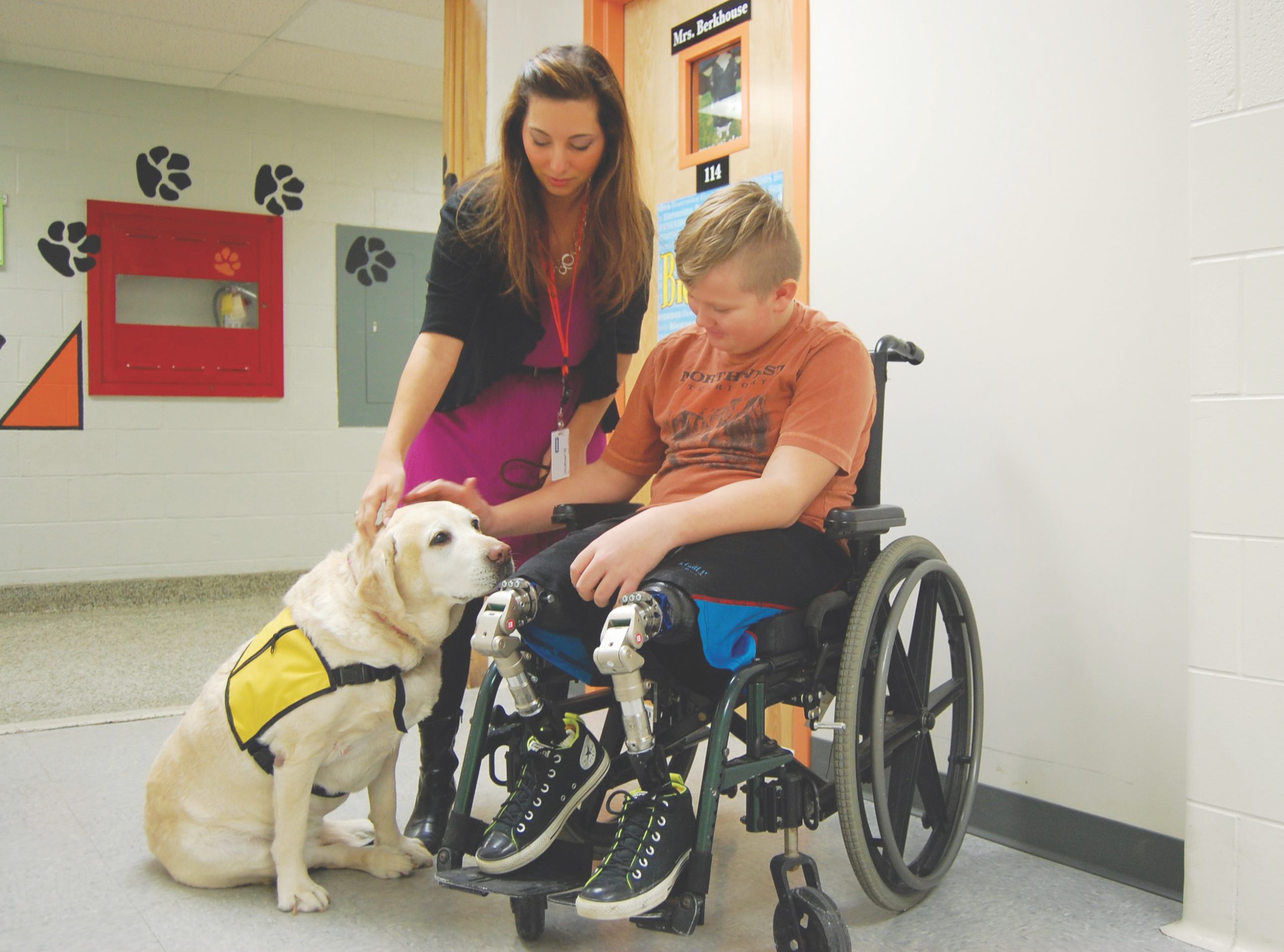 A fifth-grader who recently started using prosthetic legs visits with Bella at Green Intermediate School in Ohio. Her presence promotes feelings of safety among students, says her owner.