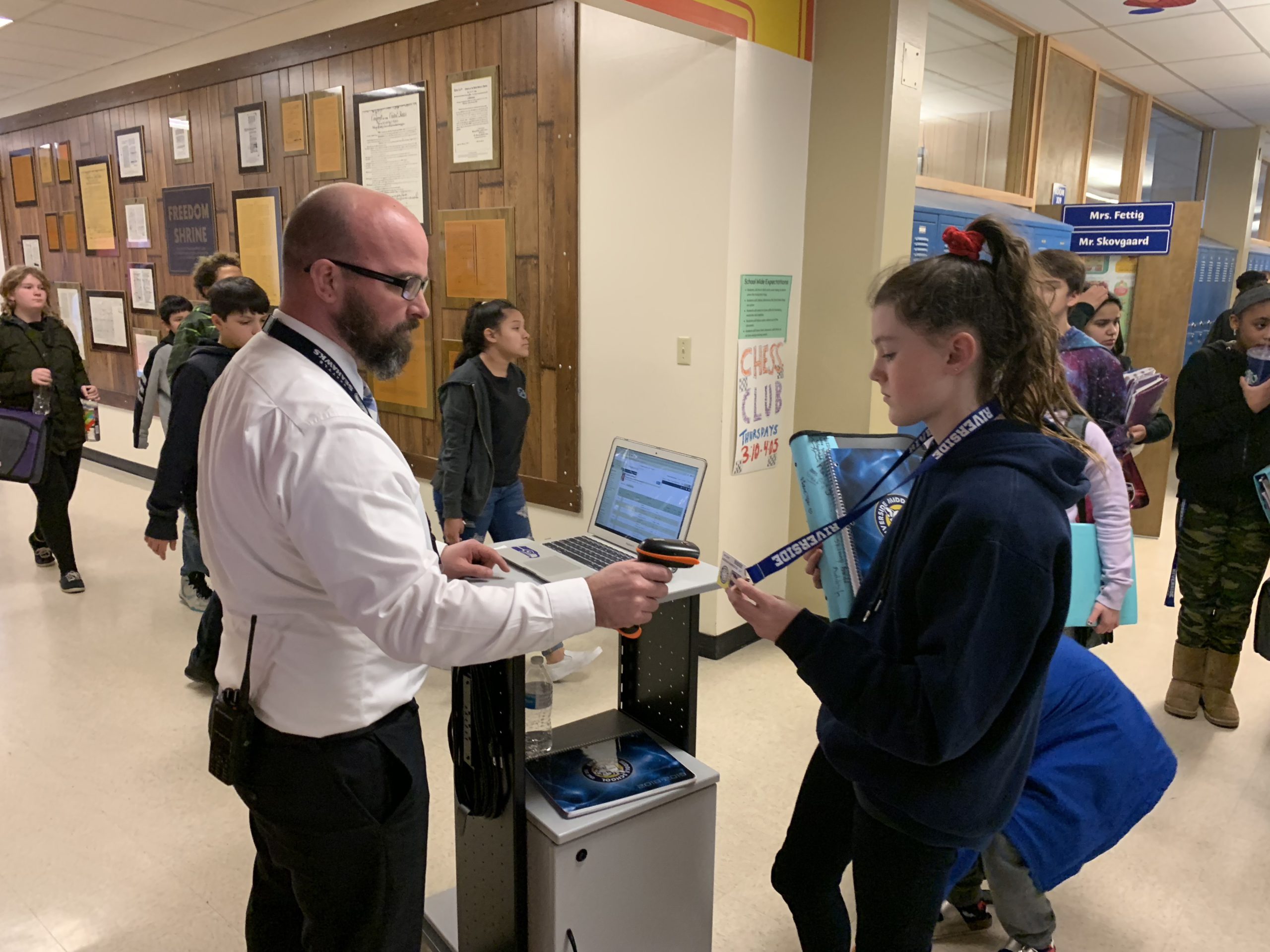 Mr. Kirkman, principal of Riverside Middle Schools, checking a student's grades so she can enter study hall.