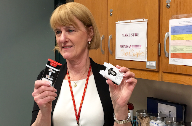 Beth Mattey, then president of the National Association of School Nurses, holds the inhalant form of naloxone, the emergency antidote that can revive students after a heroin overdose, in this photo from 2016.