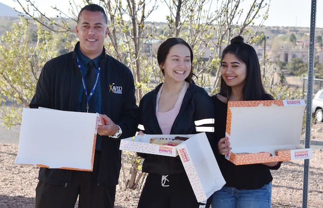 High school students who arrive before the first bell receive doughnuts as part of a comprehensive attendance initiative aimed at improving school attendance at Santa Fe Public Schools in New Mexico.