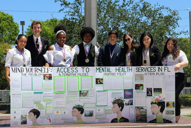 In Miami-Dade County Public Schools, the civic education curriculum teaches students how to promote a cause, such as mental health care for young people. As part of the civics curriculum, hey complete projects each year in the district’s Project Citizen Fair.