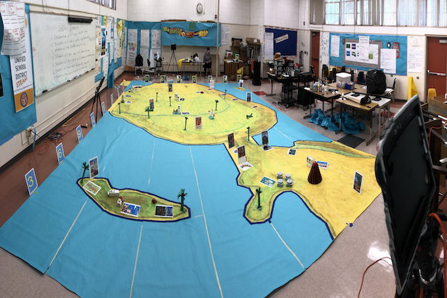 Remote students in a Compton USD middle school sent robots on educational mission on the room-size map of Latin America at Bunche Middle School.