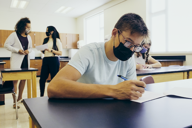 Students must wear masks and socially distance to return to school safely, even in communities where COVID transmission rates are low. (GettyImages/RichLegg)