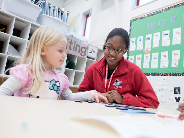 A Minnesota Reading Corps tutor works with an elementary school student pre-COVID.