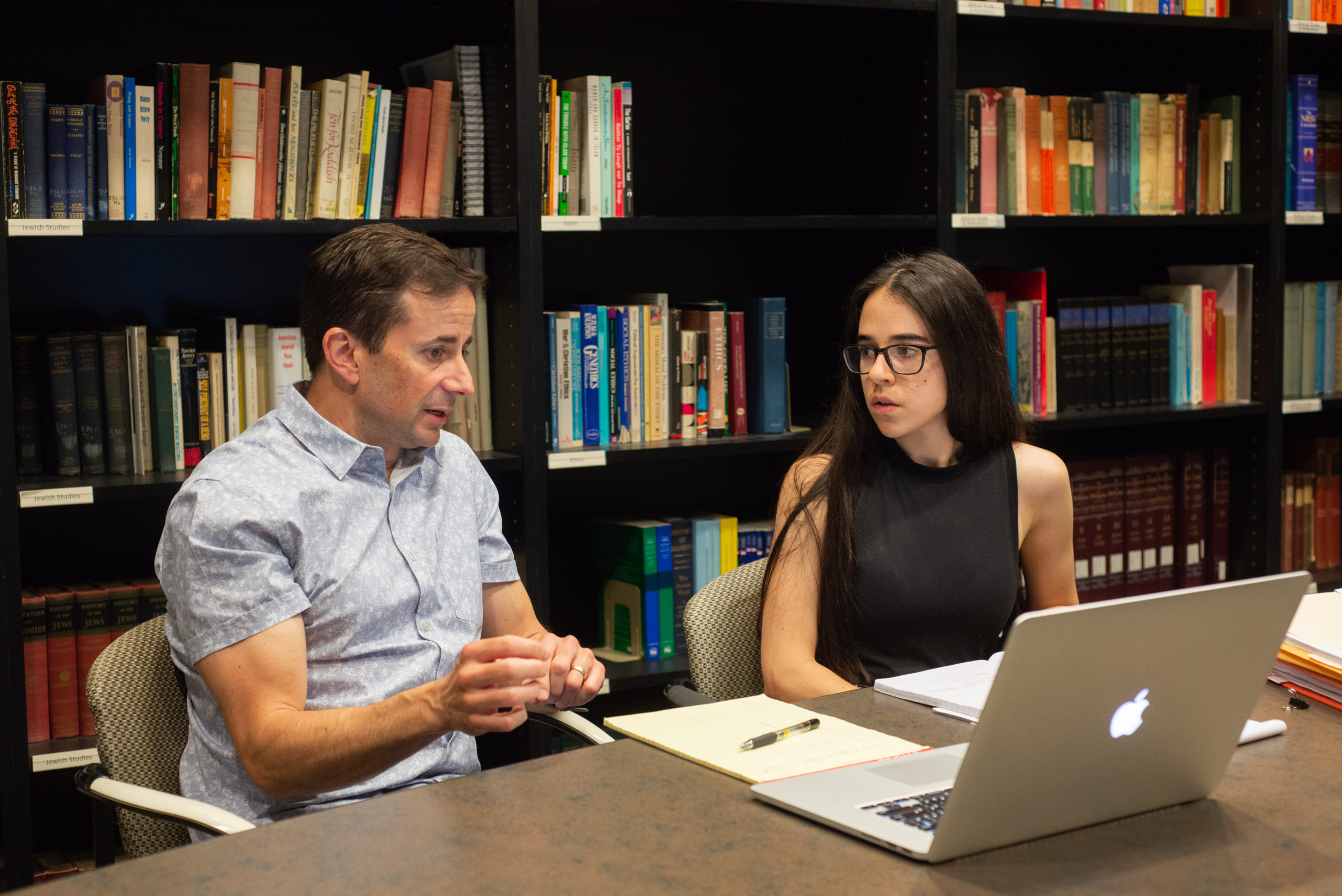 Professor of Psychology Mark Sciutto and Tovia Marinstein '20 look over data related to Shanthi Project's Mindfulness in the Classroom initiative in the summer of 2019.