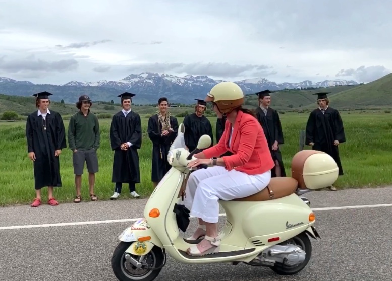 Community engagement: Superintendent Gillian Chapman was riding her Vespa to graduation in 2020 when she passed families taking graduations in photos in front of the Teton Range. 