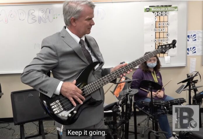 Sarasota County Schools Brennan Asplen, who is likely to be fired Tuesday, learns the bass guitar in this still from one of his 